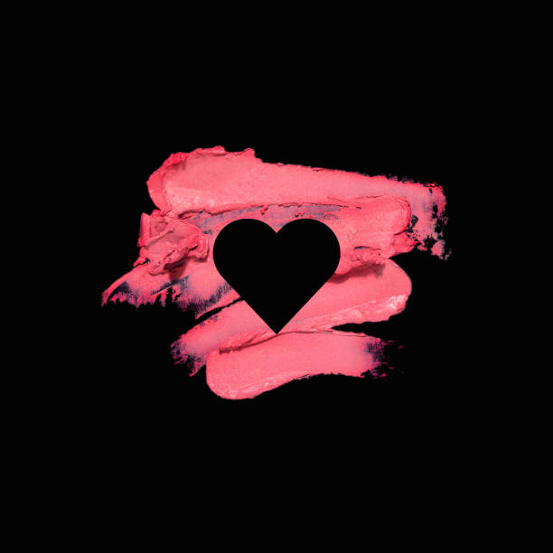 Creative concept photo of cosmetics swatches with heart on black background.