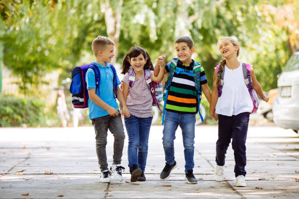 istock School children holding hands and going to school together 1130453567