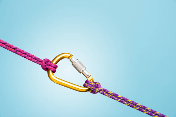 istock Gold carabiner on ropes 1130454194