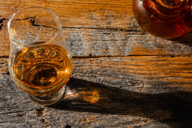 istock Irish Whiskey Bottle and Whiskey Glass on Old Wood Table 1130454966