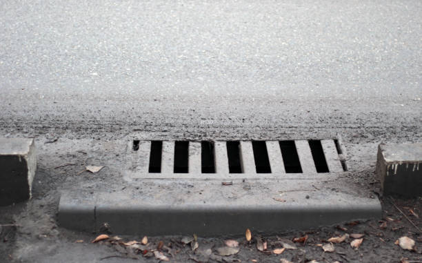 istock Sewer by footpath. Stormwater street drain 1130459678