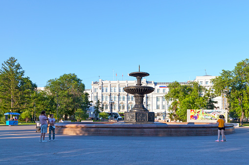 Omsk, Russia - July 17 2018: Fountain in Dzerzhinsky square in front of the building of the Administration of the city of Omsk (Russian: Администрация города Омска).