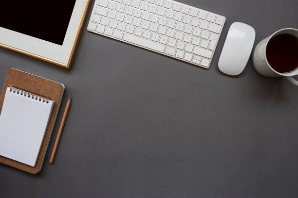 istock Home office desk with keyboard, mouse, coffee, note pad, pencil and photo frame 1130461530