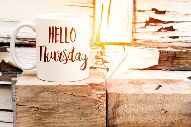 istock text HELLO thursday on cup of aromatic coffee on wooden cube 1130462335