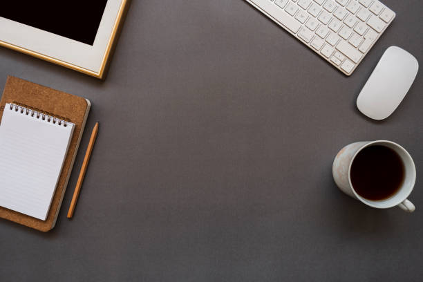istock Home office desk with keyboard, mouse, coffee, note pad, pencil and photo frame 1130462347