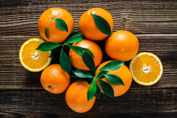 istock Fresh orange fruit on wooden background 1130462676
