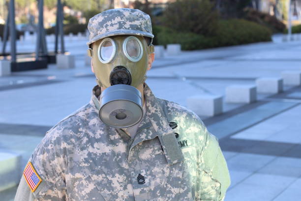 man portrait with gas mask on his face surrounded by fire flames, toxic and dangerous environment.