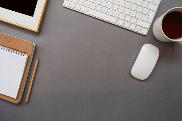 istock Home office desk with keyboard, mouse, coffee, note pad, pencil and photo frame 1130463997