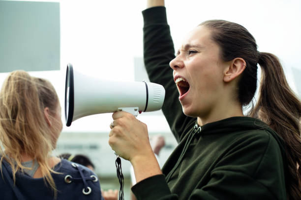 istock Female activist shouting on a megaphone 1130464027