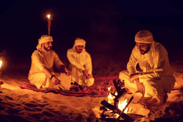istock Arab Friends Enjoying Bonfire at a Desert Camp 1130464886