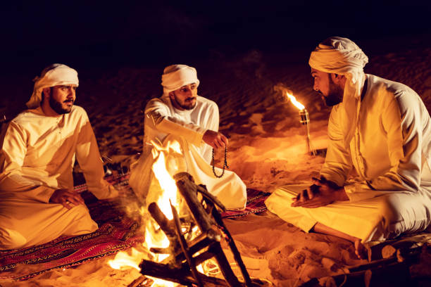 istock Arab Friends Enjoying Bonfire at a Desert Camp 1130464887
