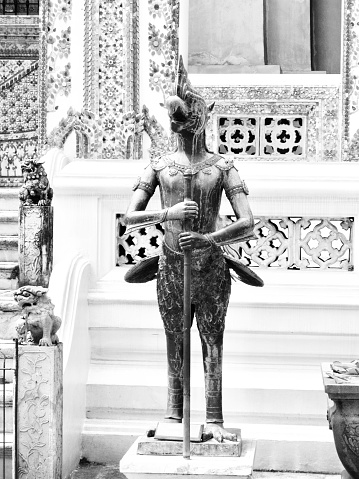 Nak Puksee Statue or The Demon of Strange Combination Between A Human, Naga and A Bird Body at Wat Phra Kaew and The Grand Palace in Bangkok, Thailand.