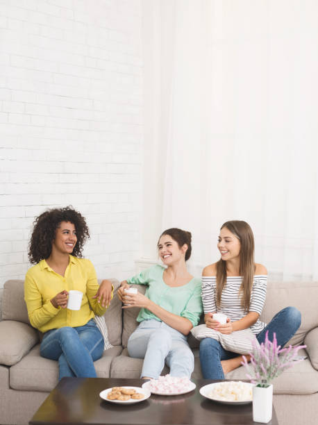 istock Three female friends with coffee cups conversing 1130465043