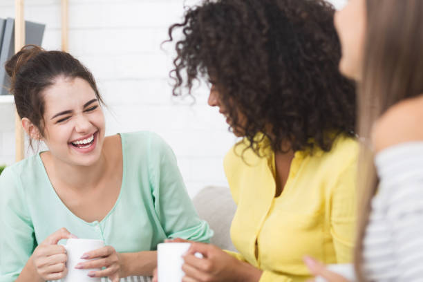 istock Diverse friends talking and drinking coffee at home 1130465053