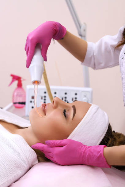 istock Receiving electric darsonval facial massage procedure. 1130465214