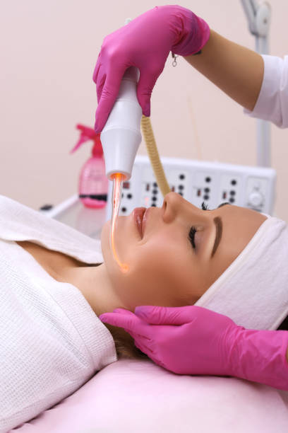 istock Receiving electric darsonval facial massage procedure. 1130465217