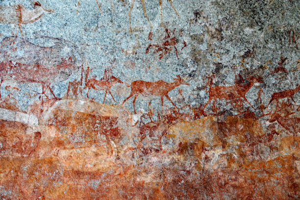 Rock art in the Nswatugi Cave in Matobo Hills, Zimbabwe Rock painting made with red ochre by the San  bushmen   in the prehistoric era. stone age stock pictures, royalty-free photos & images