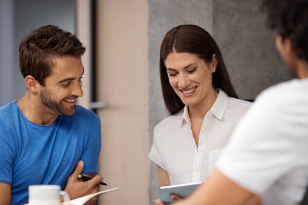 istock Businesswoman showing tablet computer to coworker 1130470185