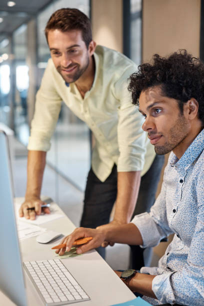 istock Businessmen looking at computer in office 1130470282