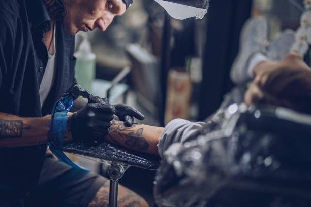 istock Busy man tattoo artist 1130470283
