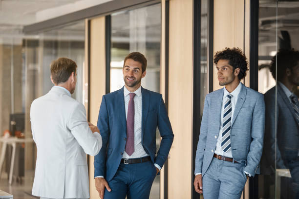 istock Businessman discussing with colleagues in office 1130470358