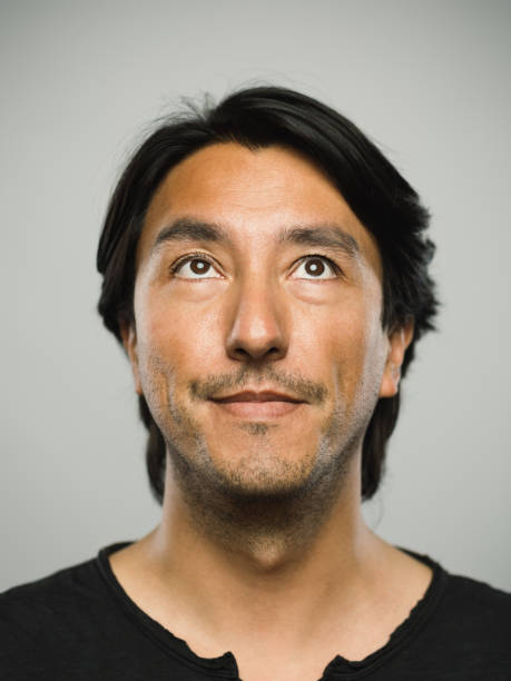 istock Portrait of real hispanic man with blank expression looking up 1130470468