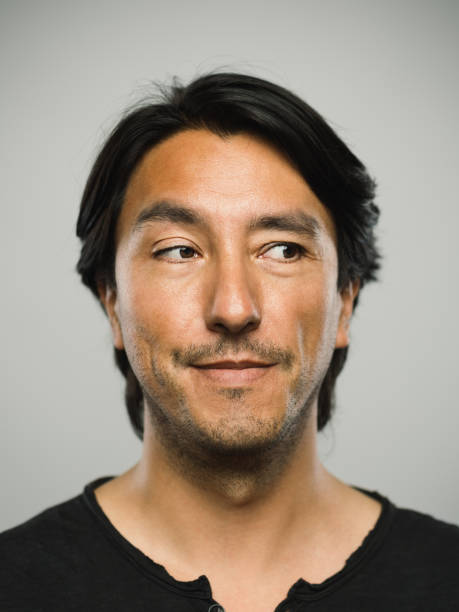 istock Portrait of real hispanic man with blank expression looking to the side 1130470632