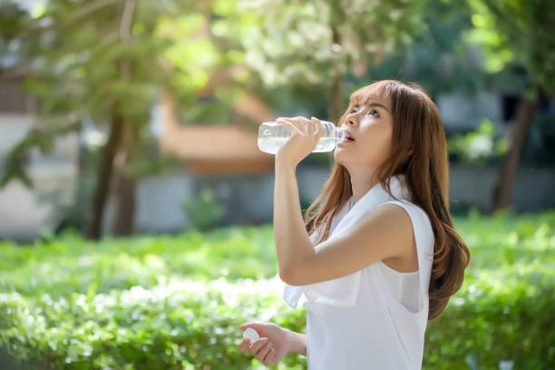 istock Asian young woman drinking water after workout exercising. 1130471846