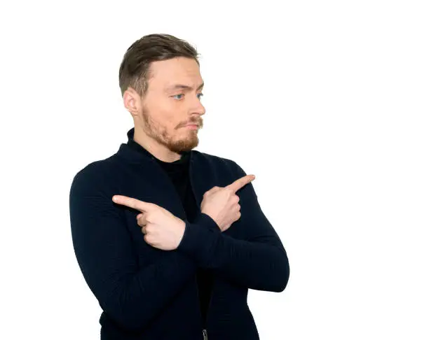 Portrait of boy pointing with crossed hands in different directions, and standing over white background.