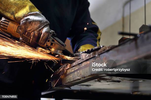 Grinding The Man Polishes Metal Rods Stock Photo - Download Image Now - Locksmith, Grinder - Industrial Equipment, Steel