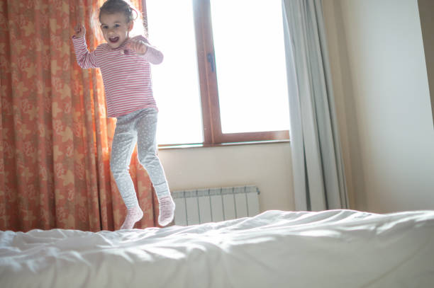 istock Beautiful girl jumping on the bed 1130476975