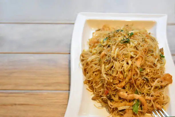 Rice noodles with Shredded Pork, stock photo - Chinese Food. Ingredients: Sprout, Pork, Rice noodles, Cong (Chinese herb: Allium fistulosum). On Wooden Table in a Chinese food Restaurant.