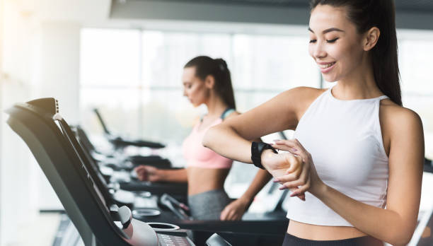istock Woman checking heart rate, running on treadmill 1130477560