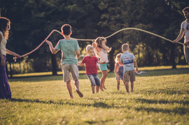 istock Group of children playing in public park 1130478671