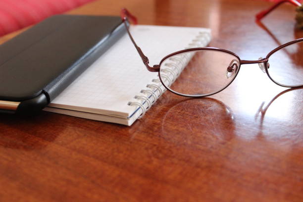 istock Reading glasses with mobile phone 1130478898