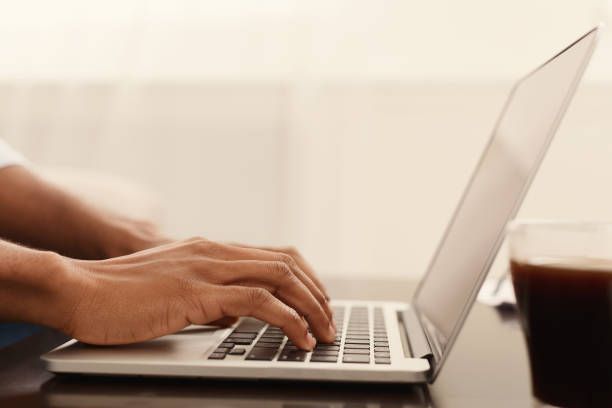 istock Black man hands typing on laptop keyboard 1130479287