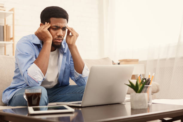 istock Concentrated black man analizing information on laptop 1130479295