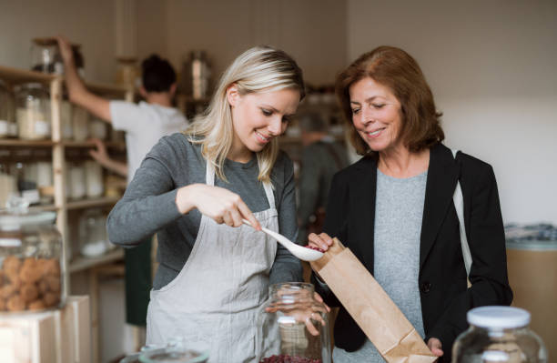 istock A female shop assistant serving a senior customer in a zero-waste shop. 1130479747