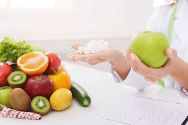 istock Doctor holding apple and sugar cubes in hands 1130481323