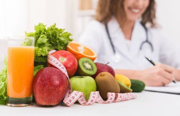 istock Female nutritionist doctor writing vegetable diet plan 1130483138