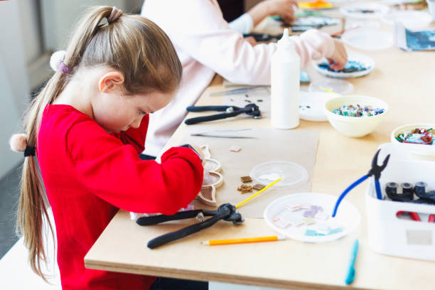 istock The girl is engaged in a ceramic mosaic workshop. 1130483479