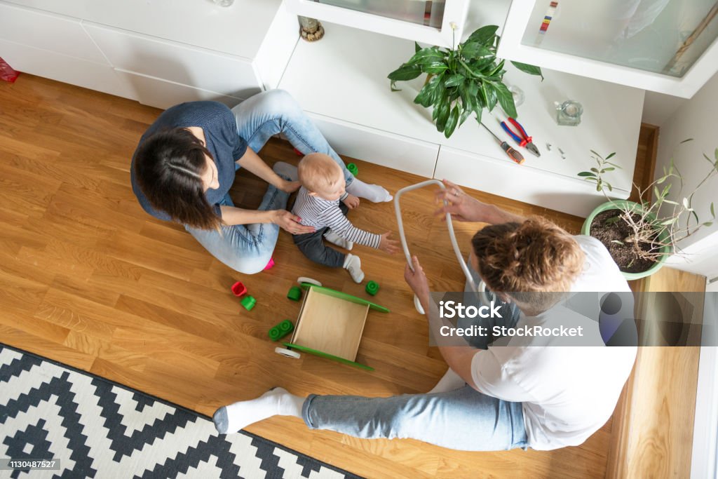 Young parents playing with baby Young family 12-17 Months Stock Photo