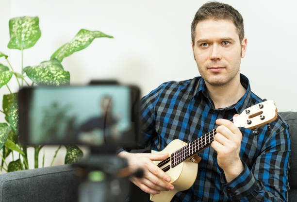istock Handsome man recording song. Vlogging concept. 1130487735