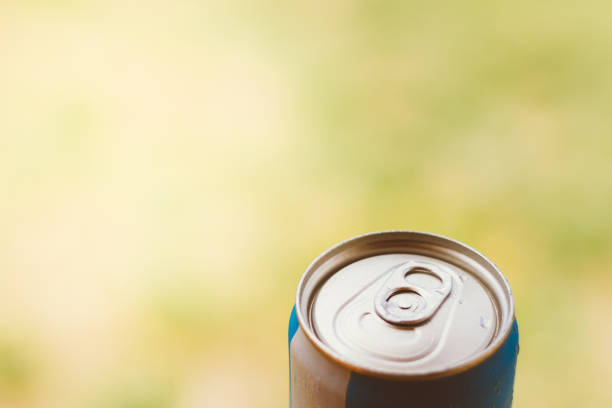 Top of a beer can or soda. Background blurred.