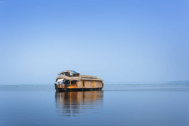 KUMARAKOM, Kerala, India : december 30, 2018 - A traditional house boat is anchored on the shores of a fishing lake in Kerala's Backwaters, India. - Image