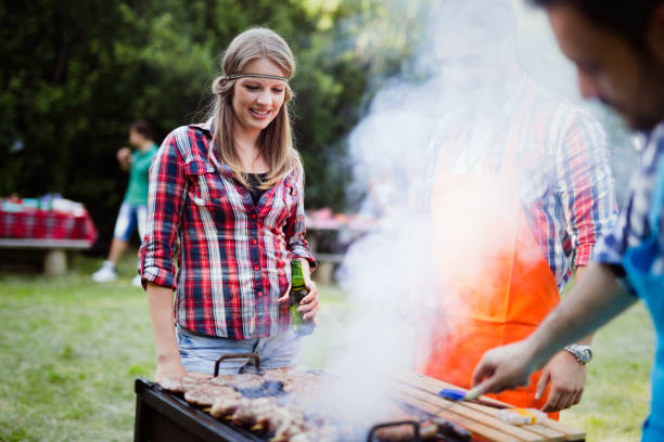istock Happy friends enjoying barbecue party 1130491341