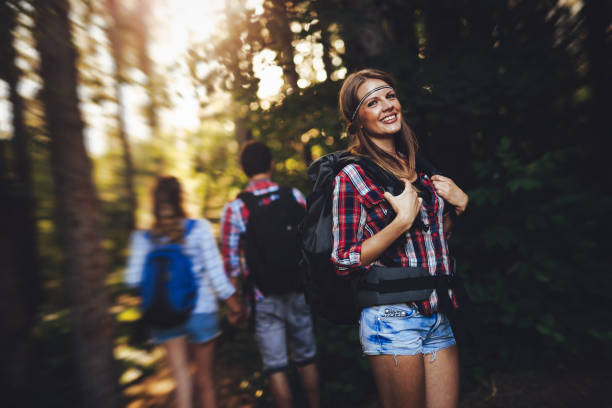 istock Group of backpacking hikers going for forest trekking 1130491429