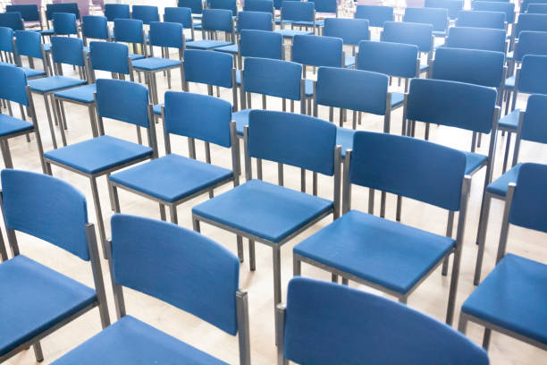 istock Rows of blue chairs in office meeting room. 1130493509