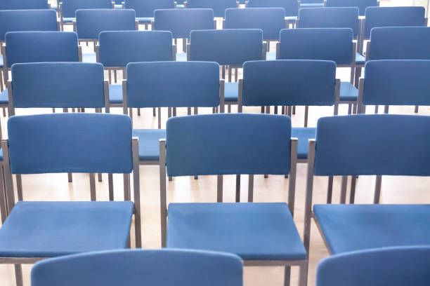 istock Rows of blue chairs in office meeting room. 1130493541