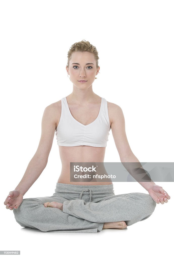 Young woman doing yoga, easy / Sukhasana position  20-29 Years Stock Photo